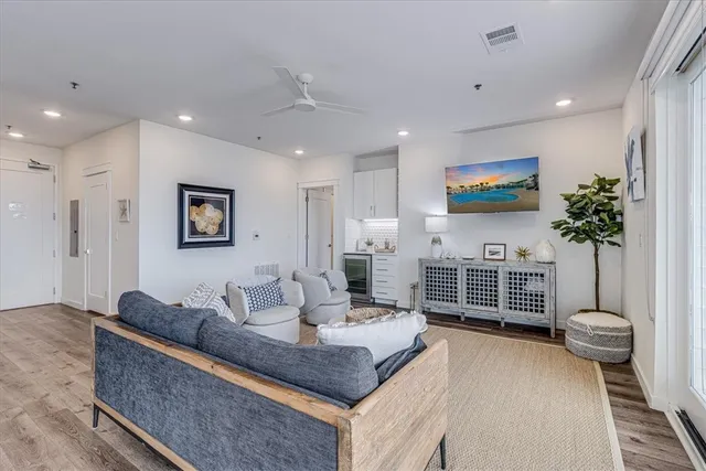 a living room with furniture a window and a flat screen tv