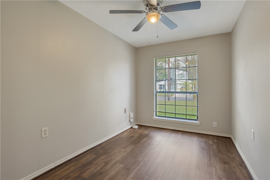 1003 East 24th Street Bryan, TX 77803 - Photo 16 of 24 Empty room featuring dark wood-type flooring and ceiling fan