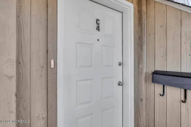 a view of a big room with wooden cabinet and a kitchen