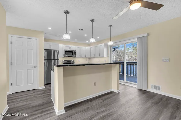 a kitchen with stainless steel appliances a refrigerator stove microwave and sink