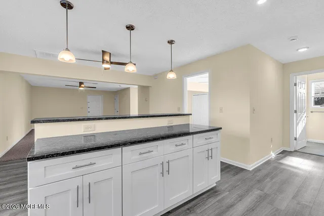 a kitchen with stainless steel appliances granite countertop a refrigerator stove and sink