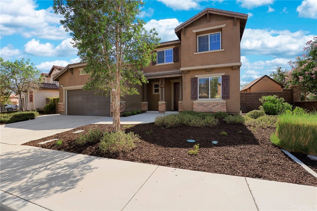 a front view of a house with garden