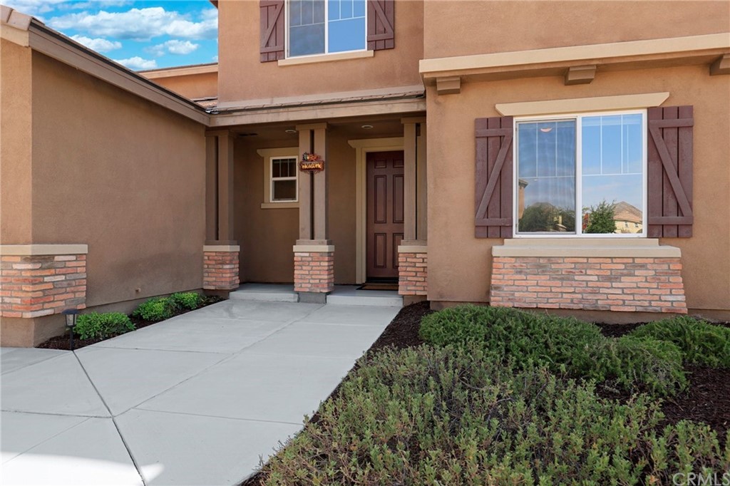 29309 First Green Lake Elsinore, CA 92530 - Photo 3 of 59 a front view of a house with a small yard