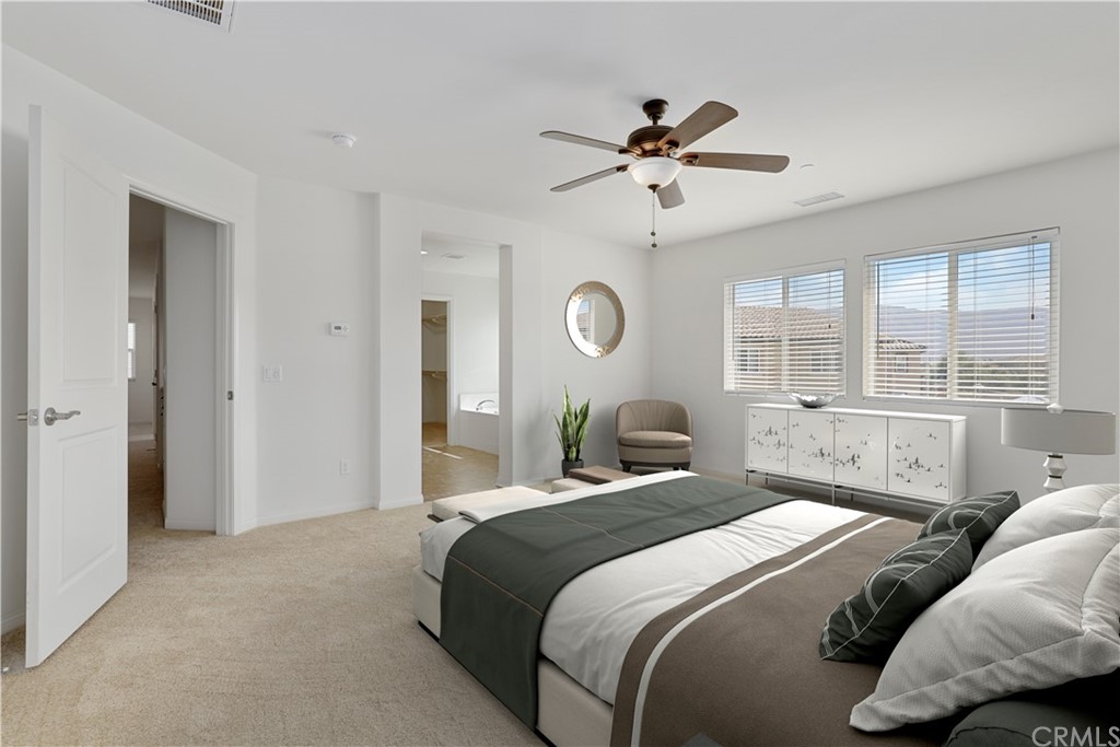 29309 First Green Lake Elsinore, CA 92530 - Photo 37 of 59 a bedroom with a large bed and windows