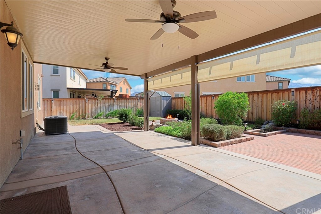 29309 First Green Lake Elsinore, CA 92530 - Photo 43 of 59 a view of a porch with a table and chairs under an umbrella