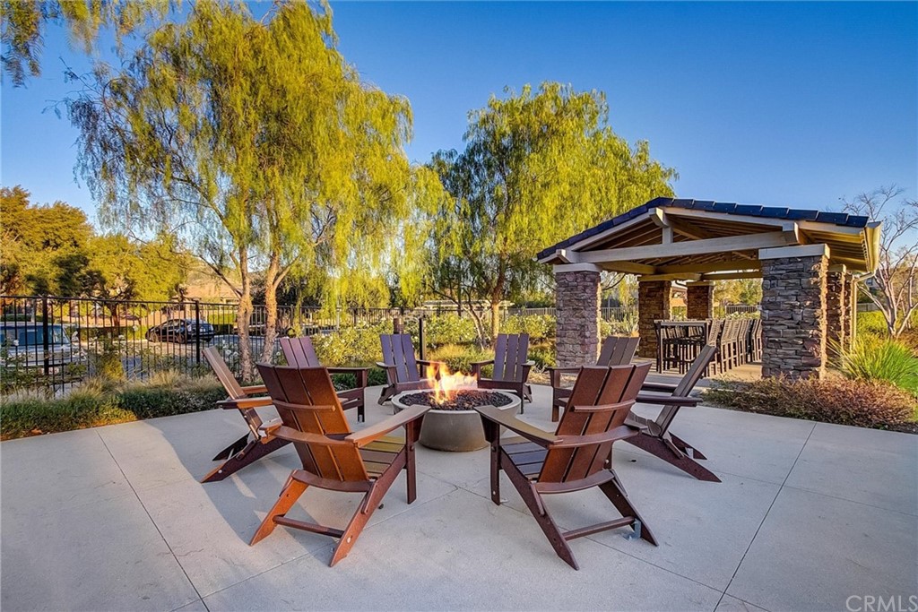 29309 First Green Lake Elsinore, CA 92530 - Photo 52 of 59 a view of patio with table and chairs under an umbrella with large trees