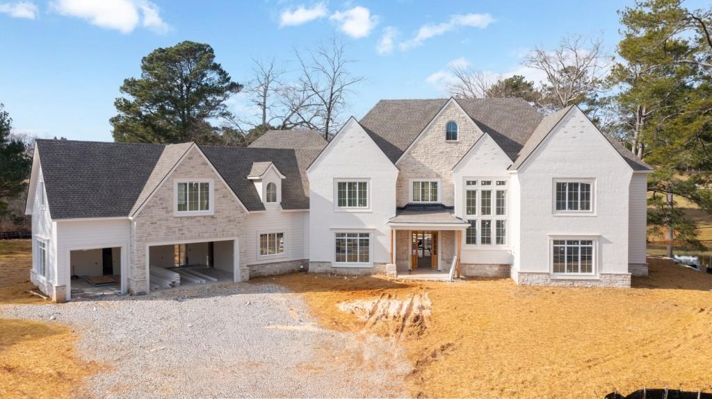 a front view of a house with a yard covered with snow in front of house