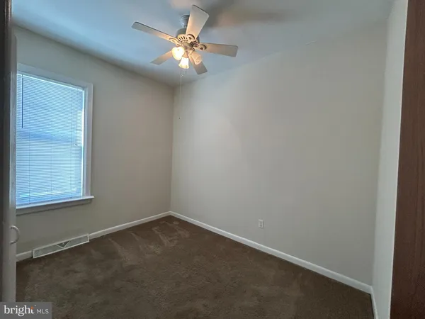 an empty room with closet area