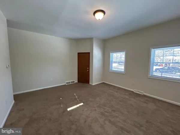 an empty room with windows and closet