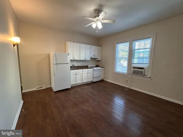 a kitchen with sink cabinets and a stove top oven