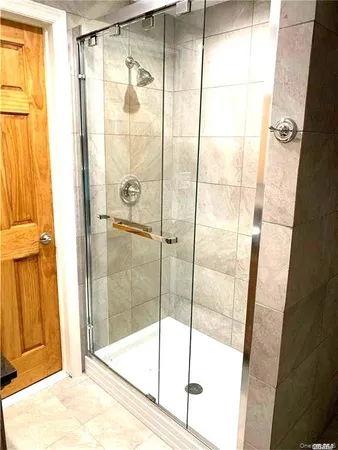 a bathroom with a glass shower door