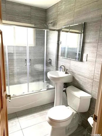 a bathroom with a sink toilet mirror and shower
