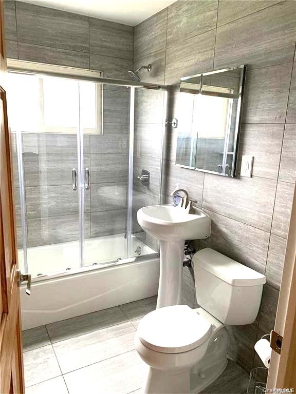 154 Kingfisher Road Levittown, NY 11756 - Photo 7 of 20 a bathroom with a sink toilet mirror and shower