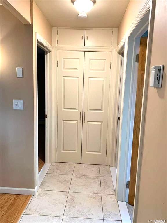 154 Kingfisher Road Levittown, NY 11756 - Photo 8 of 20 a view of a hallway with wooden floor and cabinet