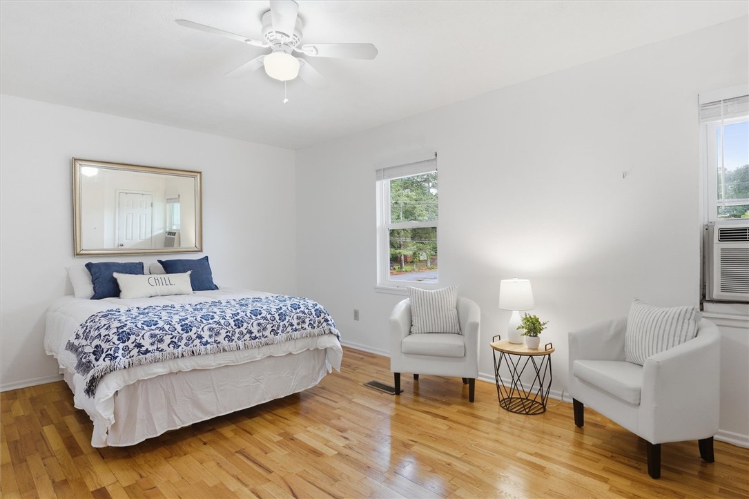 500 Concord Road Anderson, SC 29621 - Photo 15 of 23 This bright and airy bedroom features hardwood floors and a soothing color palette, offering a serene retreat.