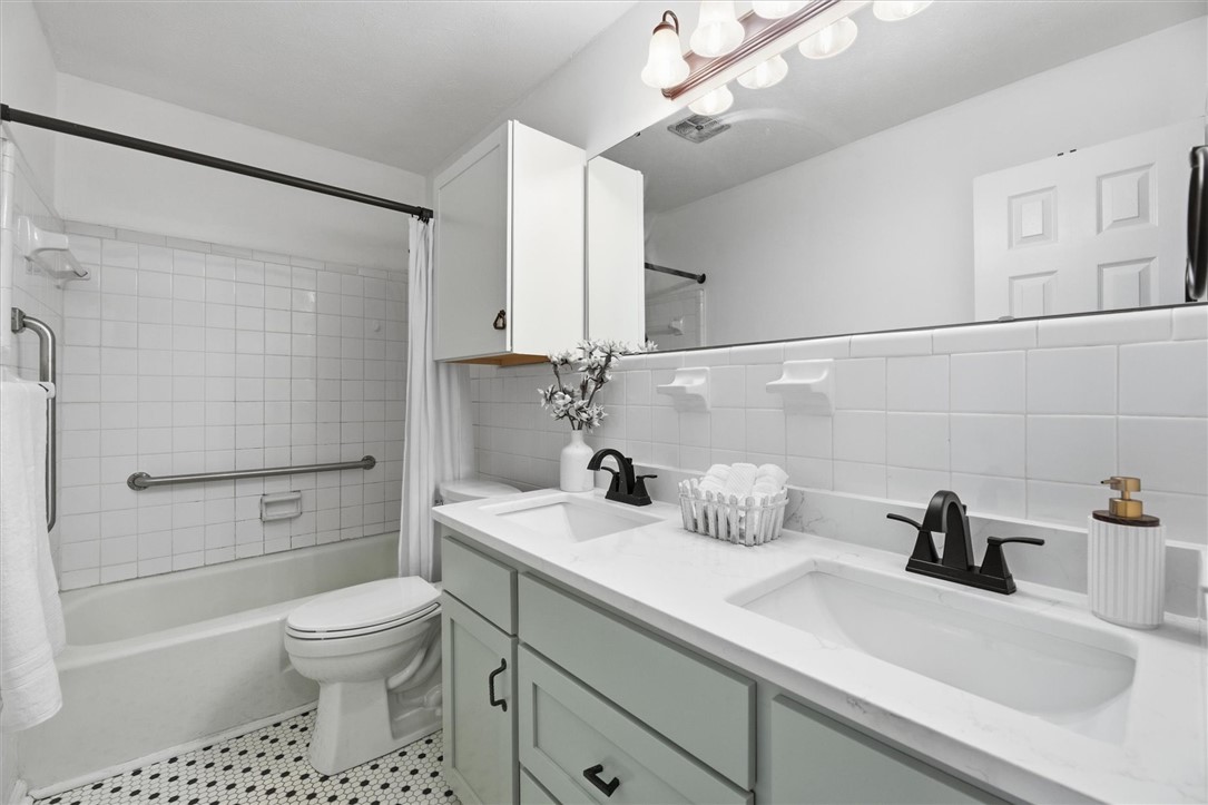 500 Concord Road Anderson, SC 29621 - Photo 18 of 23 This updated bathroom features a double vanity and a shower-tub combination for comfort.