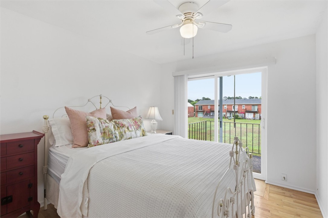 500 Concord Road Anderson, SC 29621 - Photo 19 of 23 This airy bedroom offers comfortable living with direct outdoor balcony access and classic wood flooring.