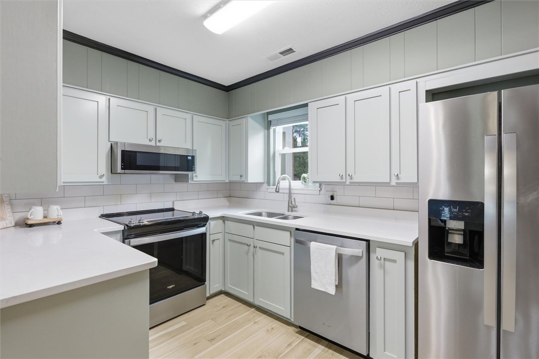500 Concord Road Anderson, SC 29621 - Photo 10 of 23 This modern kitchen features crisp cabinetry, gleaming countertops, and integrated appliances for effortless meal preparation.
