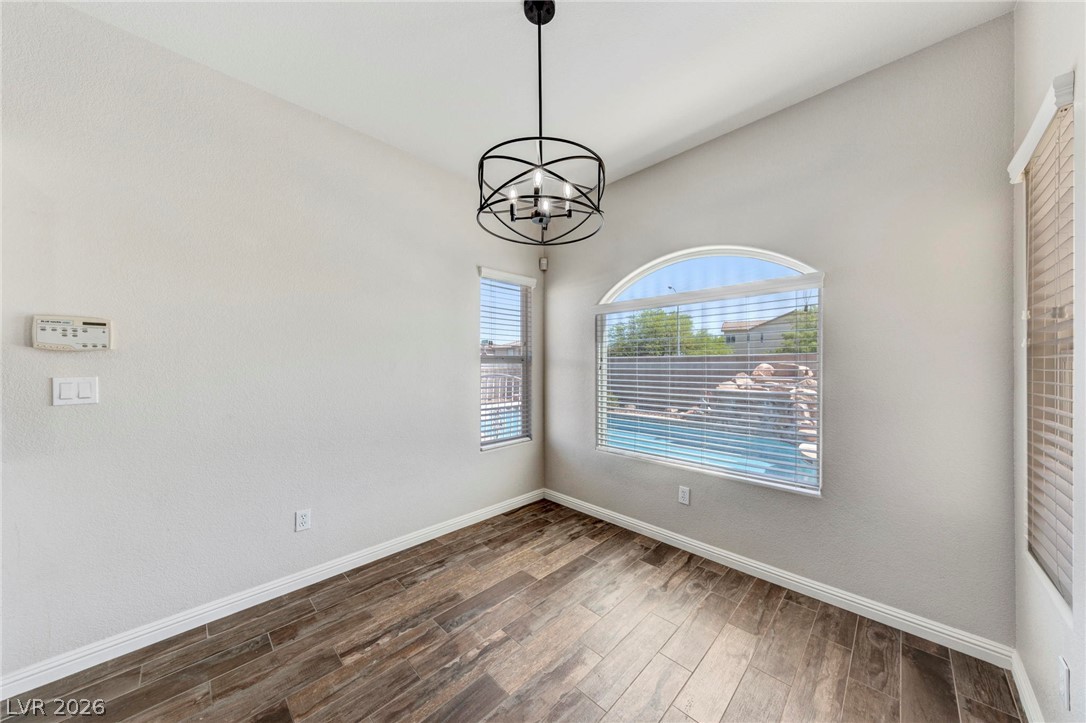 740 Aldo Rae Court, Unit NONE Henderson, NV 89052 - Photo 11 of 35 Discover a naturally illuminated space with vaulted ceilings and elegant flooring, overlooking a refreshing private pool.