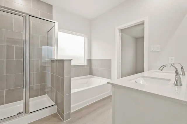 a bathroom with a tub and sink