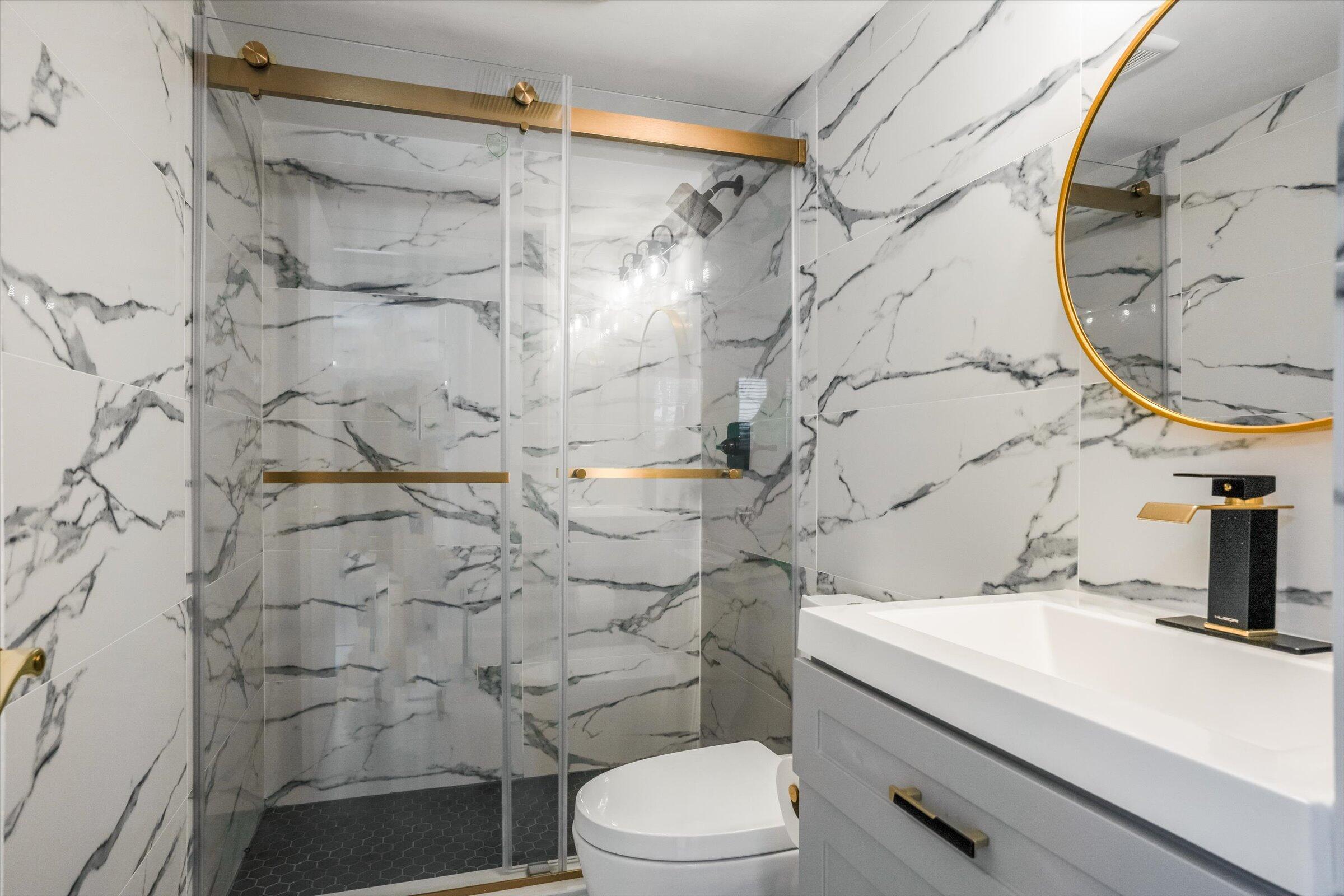 1673 Bay Road, Unit 206 Miami Beach, FL 33139 - Photo 11 of 19 a bathroom with a sink toilet and shower