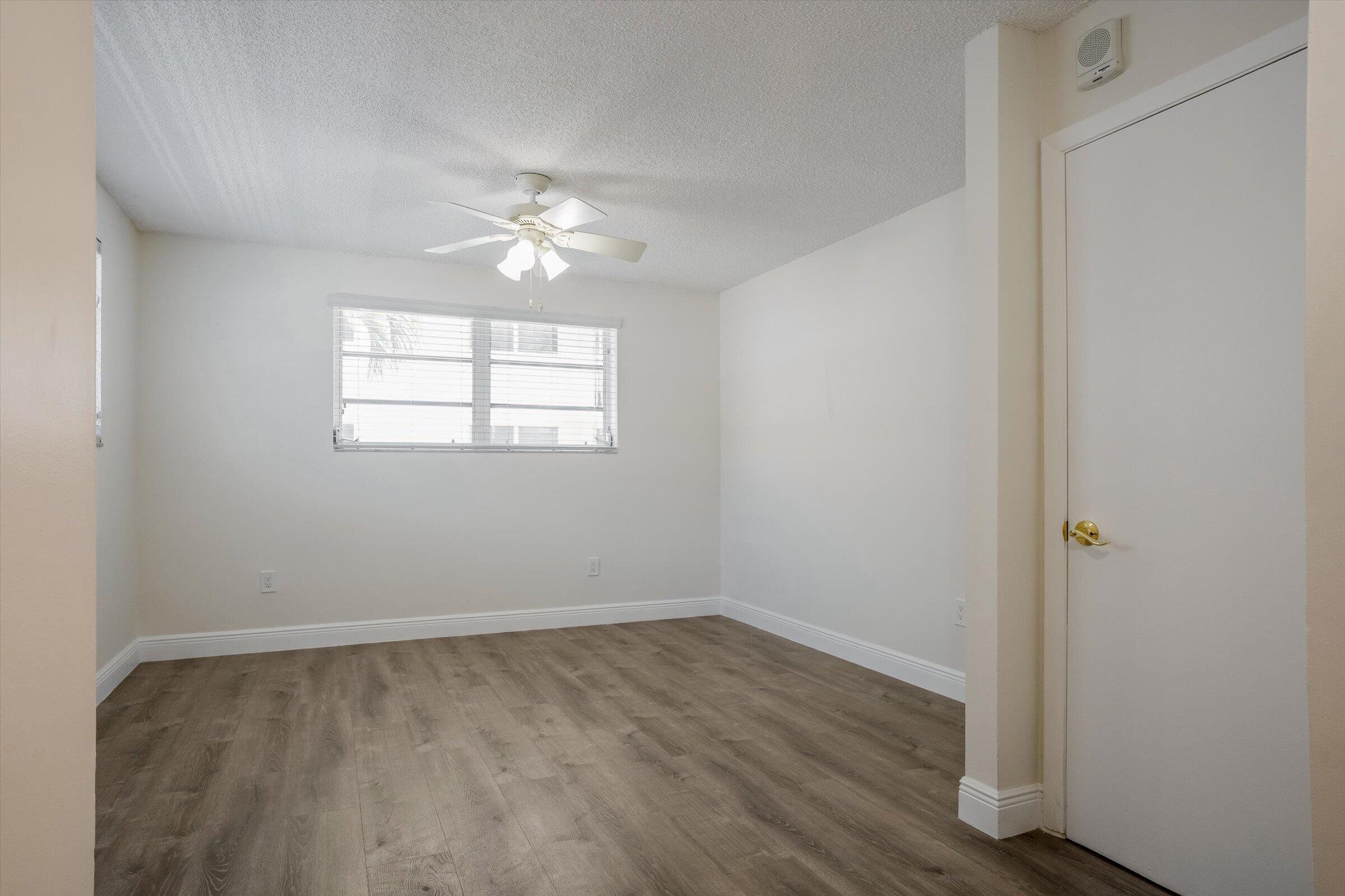 1673 Bay Road, Unit 206 Miami Beach, FL 33139 - Photo 14 of 19 wooden floor in an empty room with a window