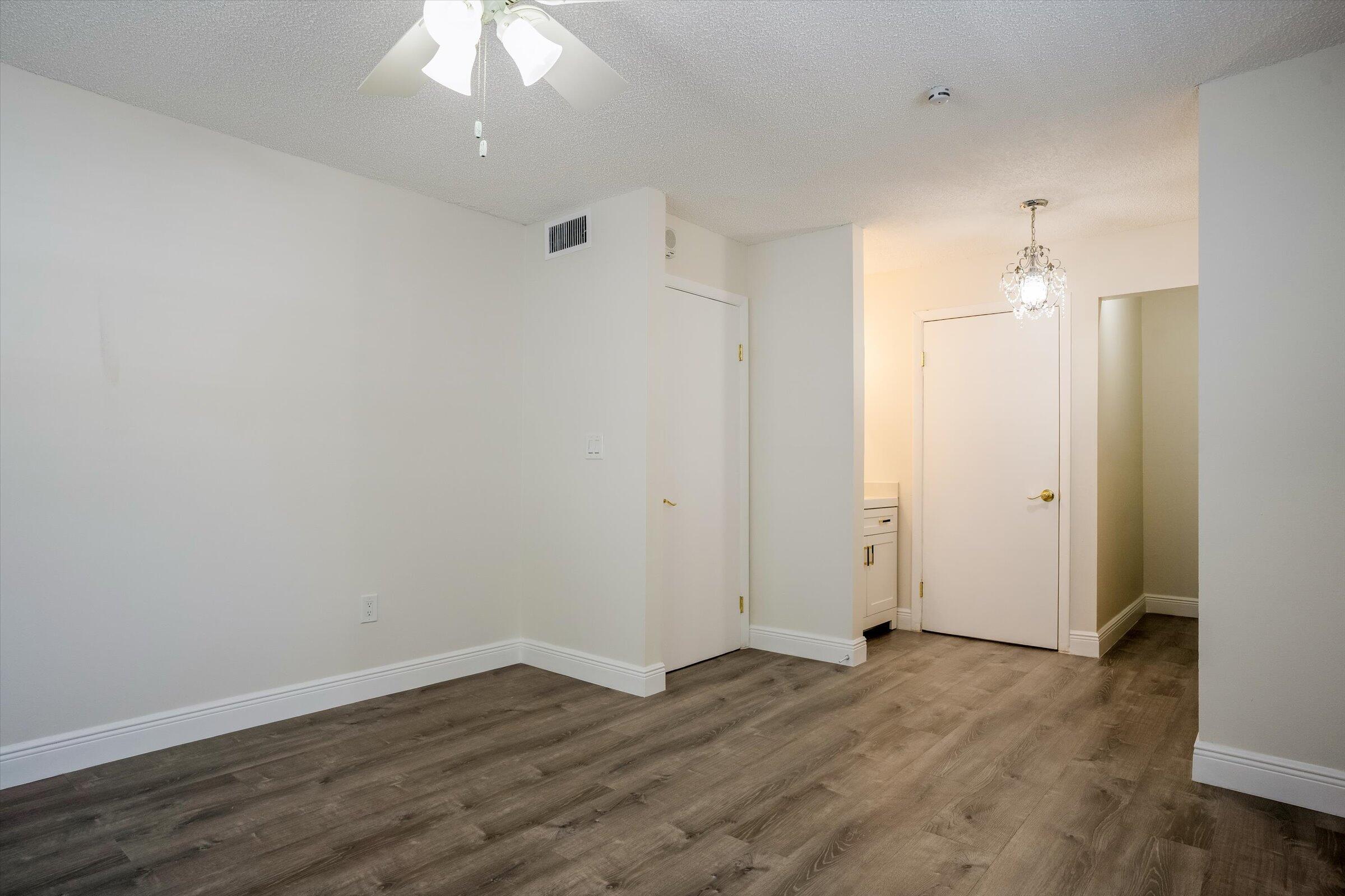 1673 Bay Road, Unit 206 Miami Beach, FL 33139 - Photo 16 of 19 an empty room with wooden floor and a ceiling fan