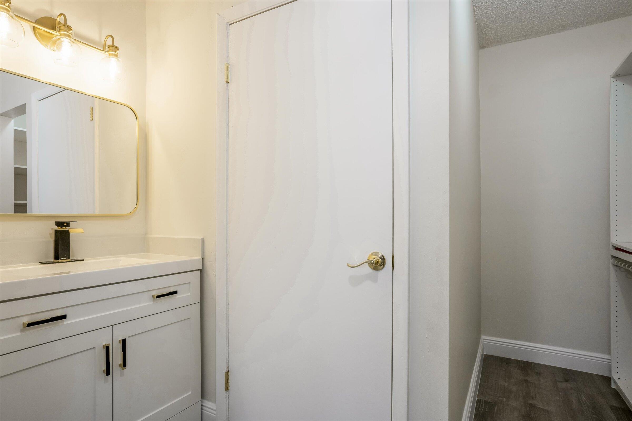 1673 Bay Road, Unit 206 Miami Beach, FL 33139 - Photo 17 of 19 a bathroom with a sink a light fixture and a mirror