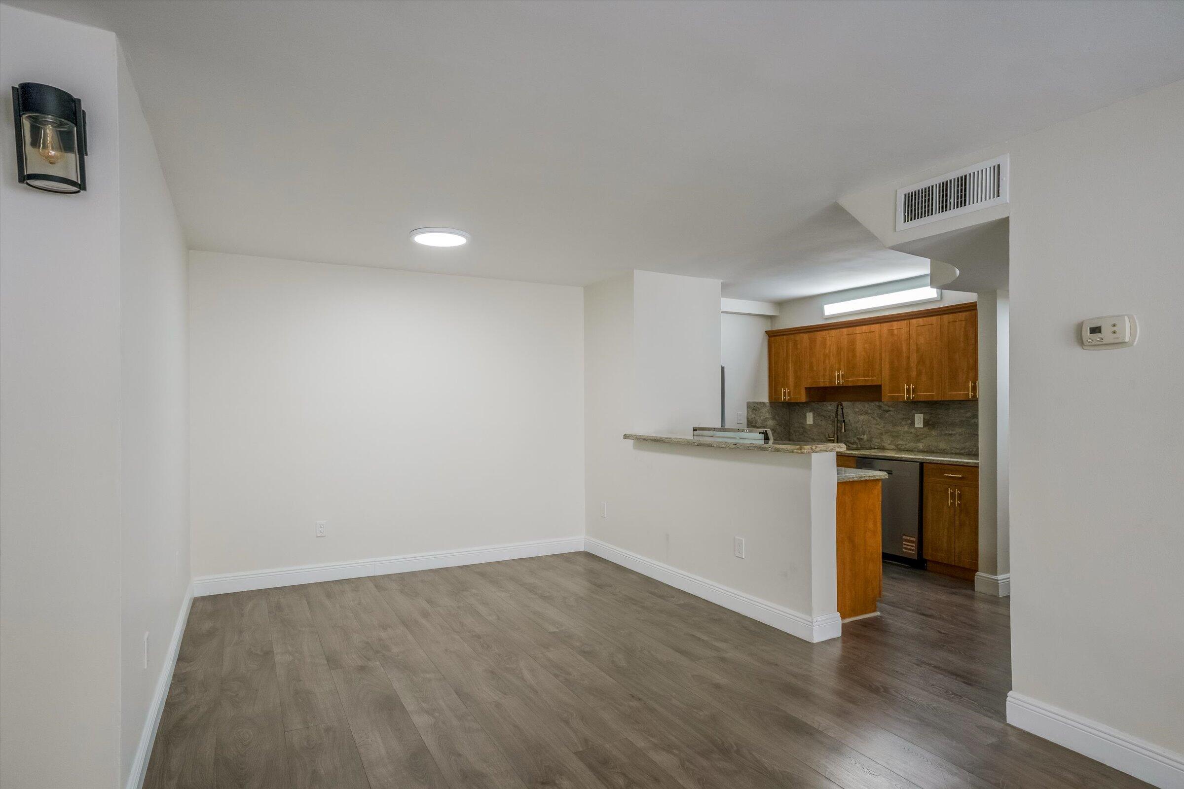 1673 Bay Road, Unit 206 Miami Beach, FL 33139 - Photo 5 of 19 a view of a kitchen with a sink stove and wooden floor