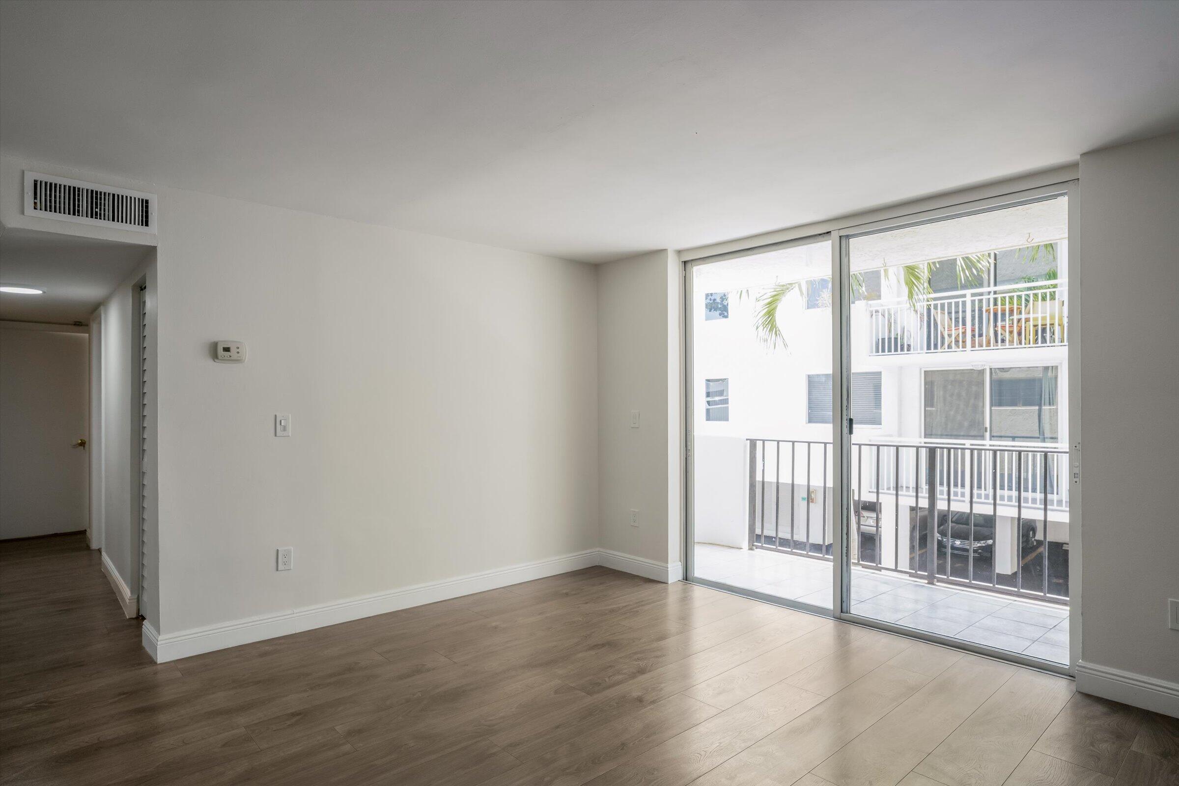 1673 Bay Road, Unit 206 Miami Beach, FL 33139 - Photo 7 of 19 wooden floor in an empty room with a window