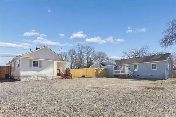 a view of white house with a yard