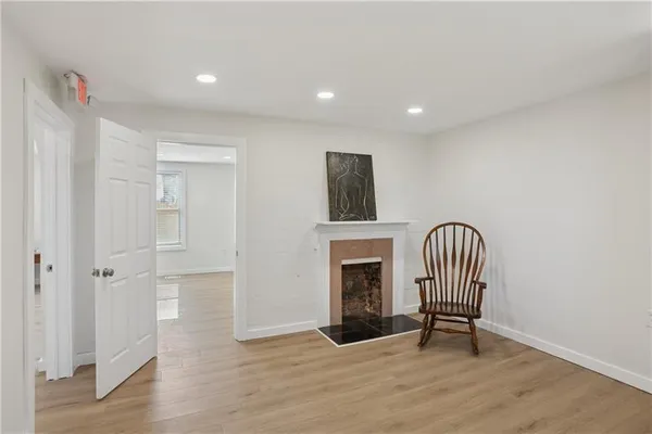 a view of a livingroom with wooden floor and workspace