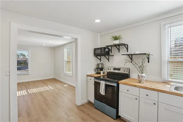 a kitchen with granite countertop a stove and a sink