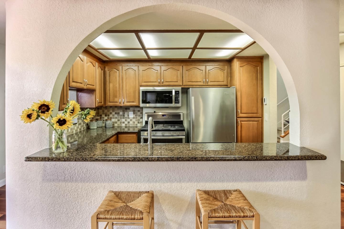 104 Redding Road Campbell, CA 95008 - Photo 7 of 23 a kitchen with a refrigerator and a sink