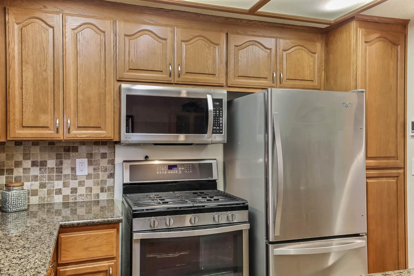 104 Redding Road Campbell, CA 95008 - Photo 8 of 23 a kitchen with granite countertop a refrigerator stove and cabinets