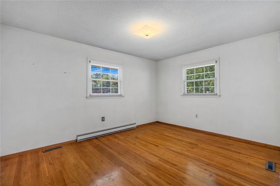 2101 Old Spring Drive Anderson, SC 29625 - Photo 17 of 36 Hardwood floors and generous natural light define this inviting bedroom.