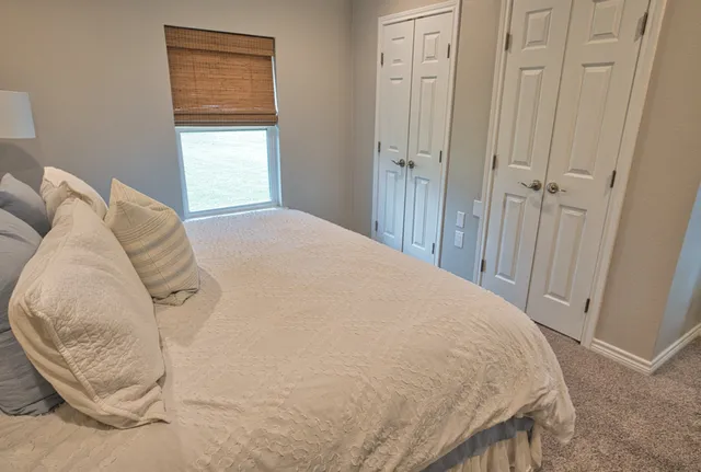 a bathroom with a granite countertop toilet sink and mirror
