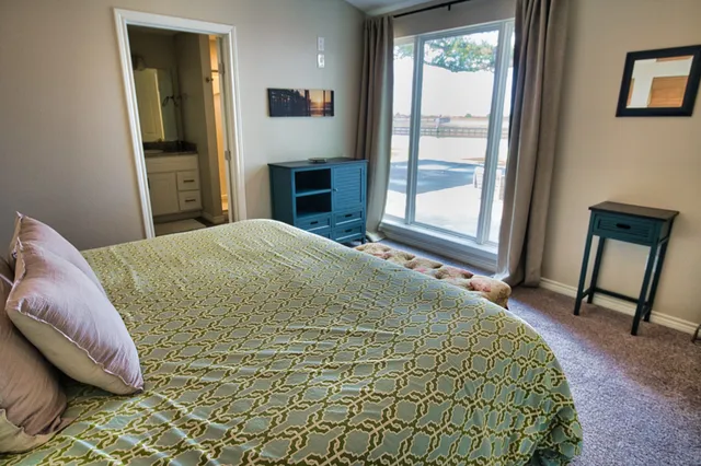 a bedroom with a bed and a night stand