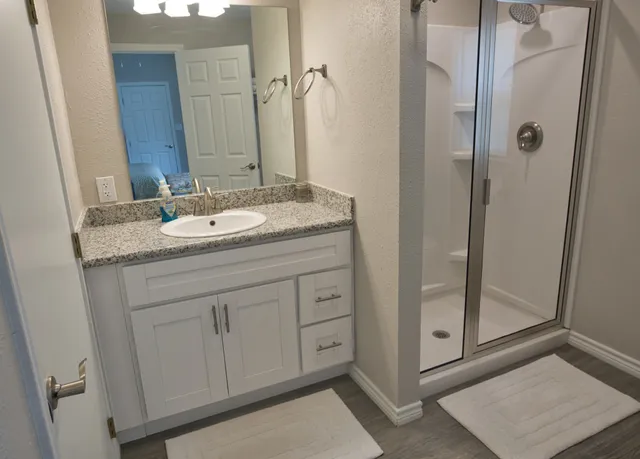 a spacious bedroom with two beds and a couch