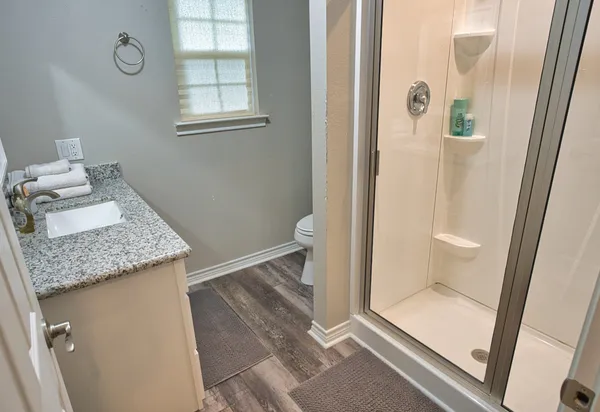 a bathroom with a granite countertop sink and a mirror