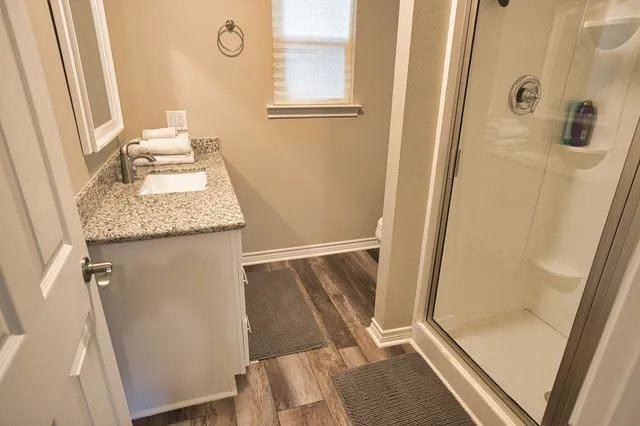 a large bed sitting in a bedroom next to a window