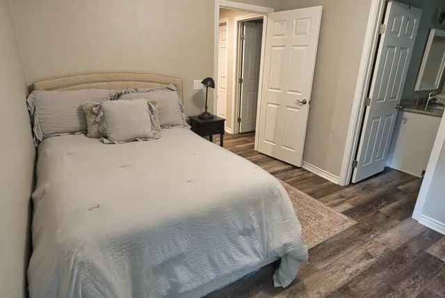 a bedroom with bed and window