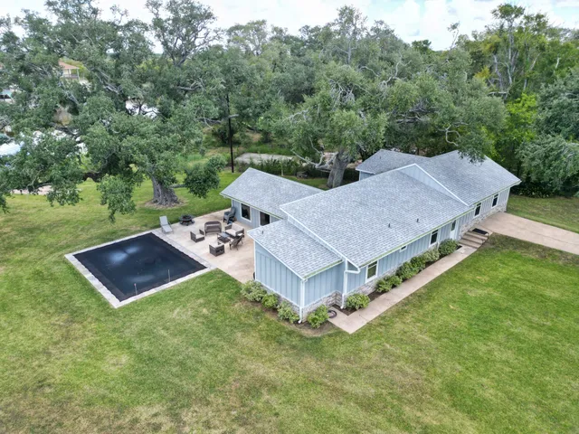 an aerial view of a house with garden space and lake view