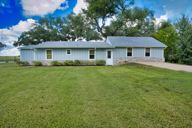a view of a water pond with green field
