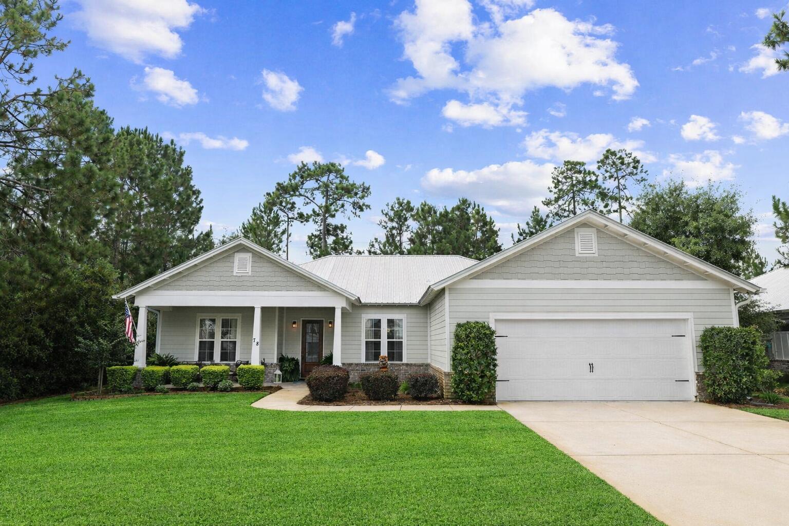 a front view of a house with a yard and porch