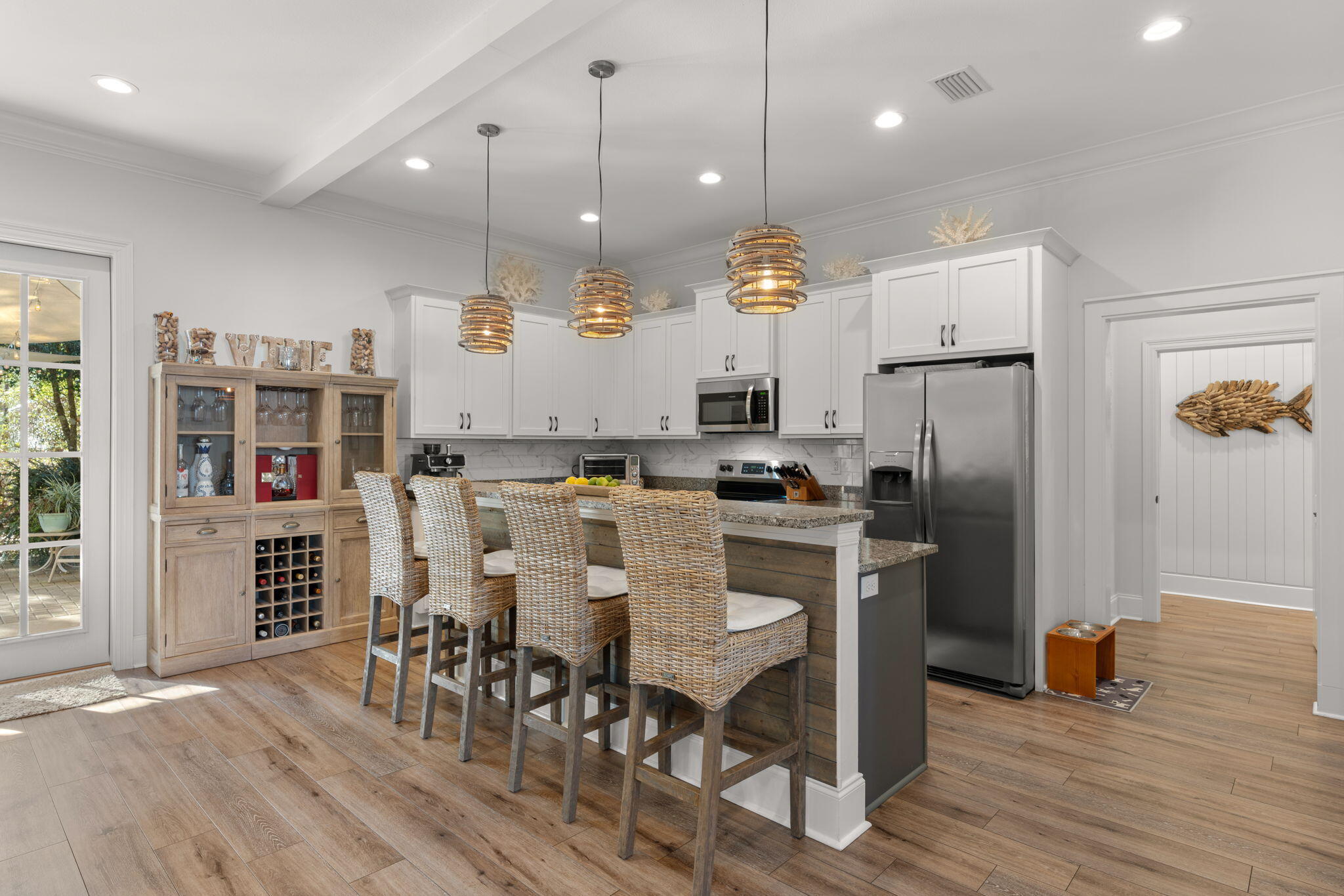78 Grizzly Street Freeport, FL 32439 - Photo 14 of 65 a kitchen with stainless steel appliances kitchen island granite countertop a refrigerator a stove a kitchen island a dining table and chairs with wooden floor