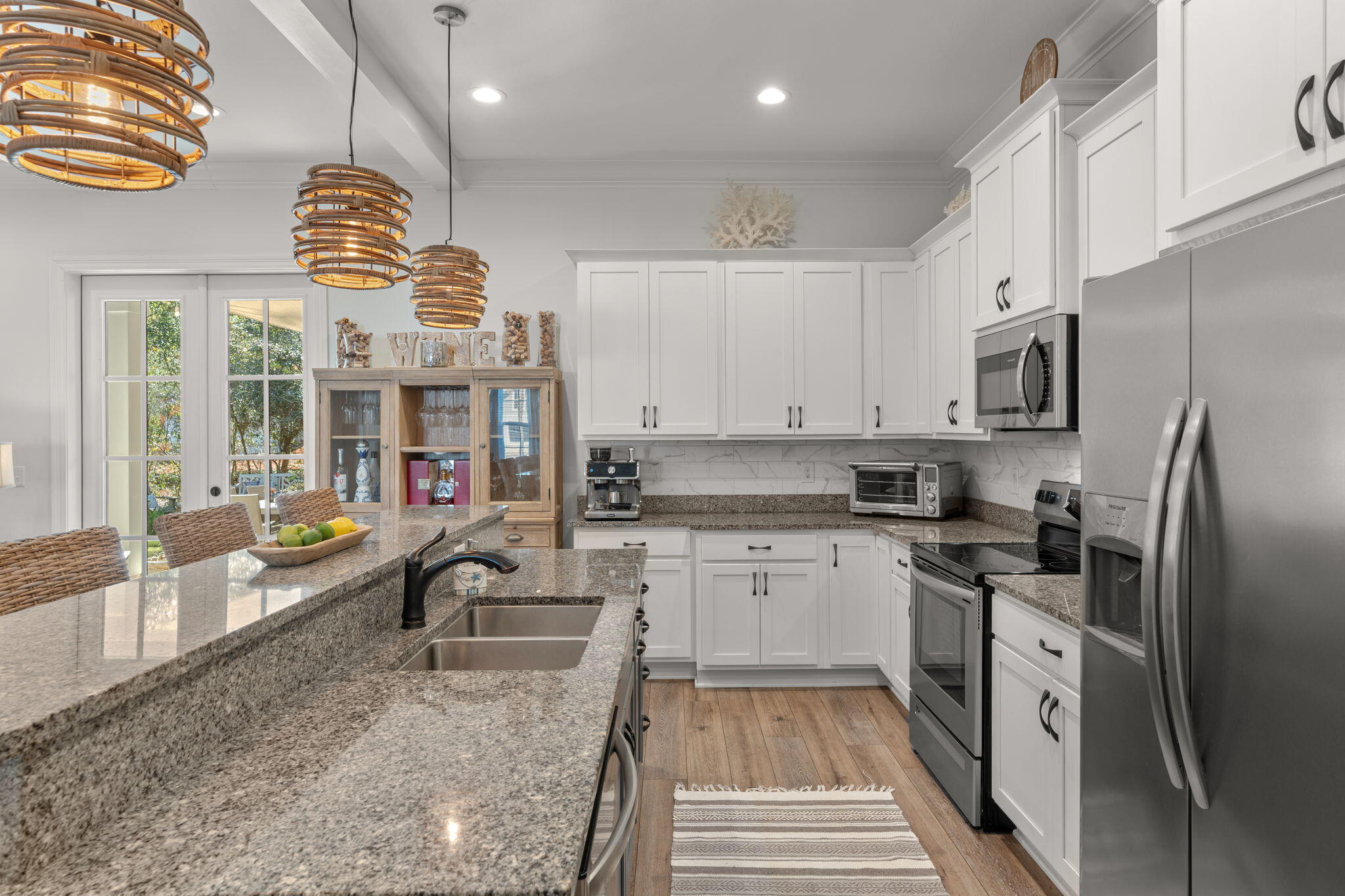 78 Grizzly Street Freeport, FL 32439 - Photo 16 of 65 a large kitchen with stainless steel appliances granite countertop a sink stove and refrigerator