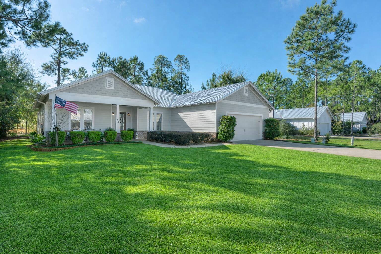 78 Grizzly Street Freeport, FL 32439 - Photo 2 of 65 a front view of a house with a garden