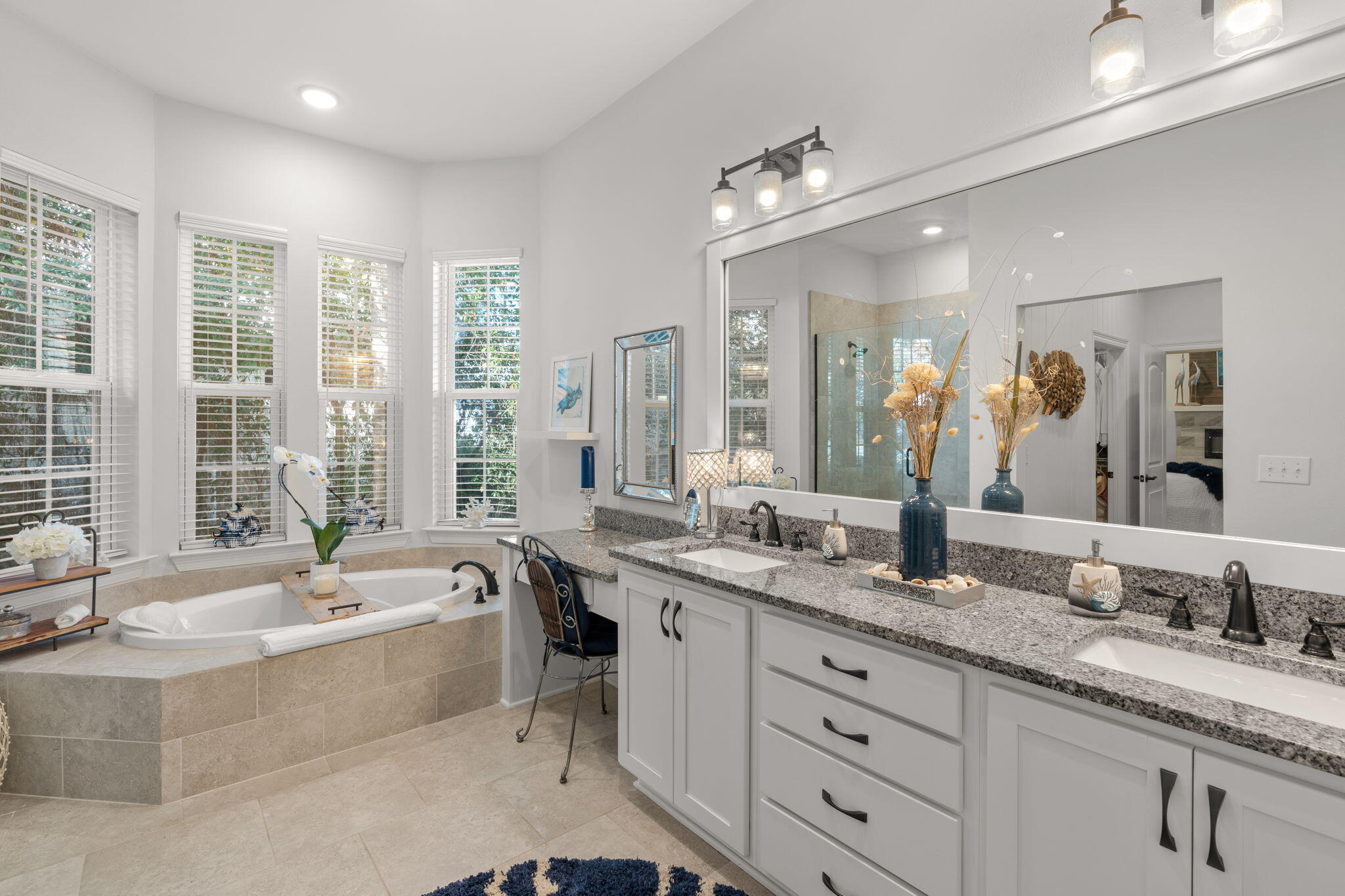 78 Grizzly Street Freeport, FL 32439 - Photo 32 of 65 a bathroom with a granite countertop sink large mirror and a bathtub