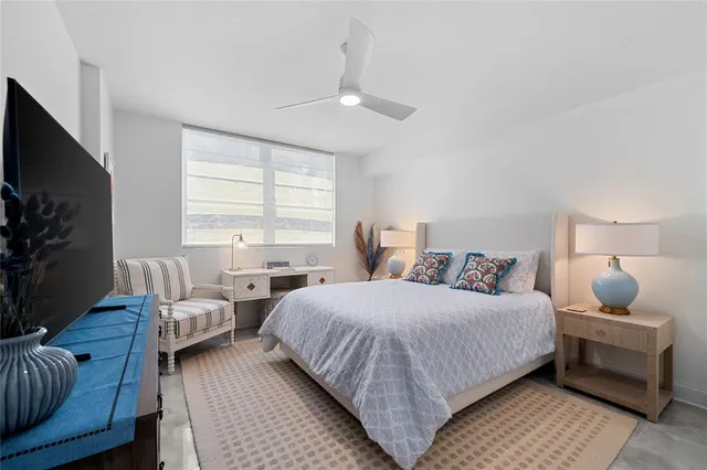 a bedroom with a bed and a couch